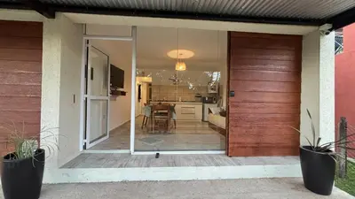 a sliding glass door of a house with a kitchen at Brisas Rumipal dúplex premium Villa Rumipal in Villa Rumipal