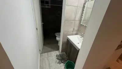 a small bathroom with a toilet and a sink at Brisas Rumipal dúplex premium Villa Rumipal in Villa Rumipal