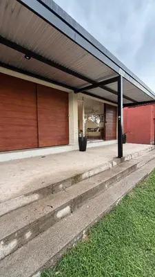 a building with two garage doors on the side at Brisas Rumipal Dúplex Premium in Villa Rumipal