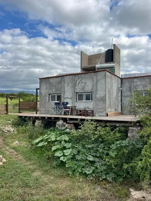 a house on a wooden bridge with a building at Hostal El Portillo in Arroyo de Los Patos