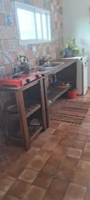 a kitchen with a wooden table and a sink at Hostal El Portillo in Arroyo de Los Patos