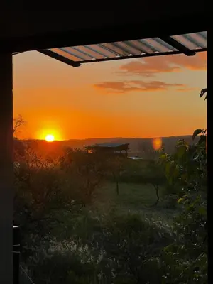 a sunset seen from the window of a house at Hostal El Portillo in Arroyo de Los Patos