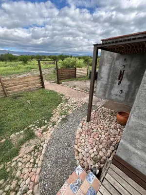a building with a fence next to a yard at Hostal El Portillo in Arroyo de Los Patos