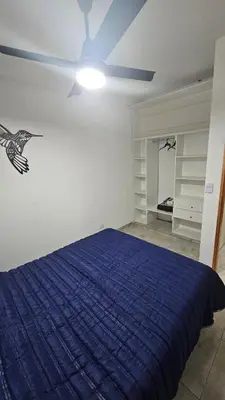 a bedroom with a blue bed and a ceiling fan at Urbana Home Córdoba in Cordoba