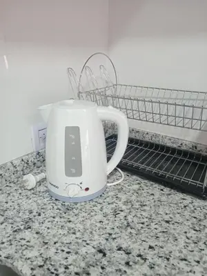 a tea kettle on a counter next to a drying rack at Urbana Home Córdoba in Cordoba