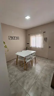 a dining room with a table and a window at Urbana Home Córdoba in Cordoba