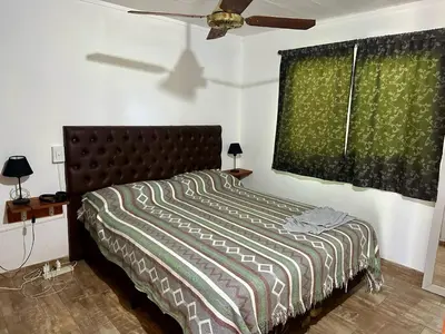 a bedroom with a bed and a ceiling fan at Cabañas Enki in La Paz