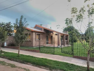 a house with a fence in front of it at Casa Amapola in Embalse