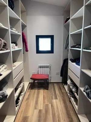 a walk in closet with a red bench in the middle at Casa en Molvento in Villa Los Molinos