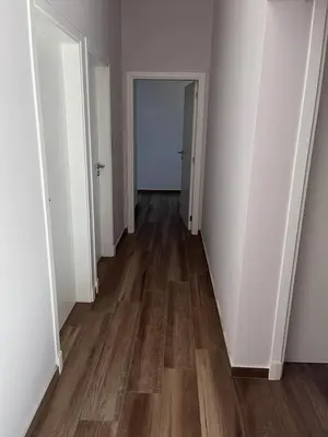an empty hallway with wooden floors and white walls at Casa en Molvento in Villa Los Molinos