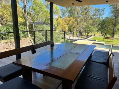 a wooden table and chairs on a porch with a view at Casa en Molvento in Villa Los Molinos