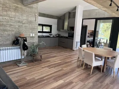 a kitchen and dining room with a wooden table and chairs at Casa en Molvento in Villa Los Molinos