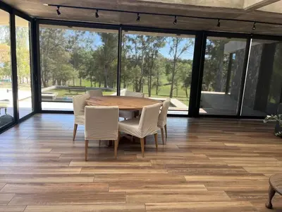 a dining room with a wooden table and chairs at Casa en Molvento in Villa Los Molinos