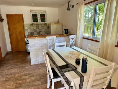 a kitchen with a table and chairs in a room at Cabañas Enki in La Paz