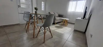 a living room with a table and chairs and a couch at Moderno departamento a estrenar in Alta Gracia