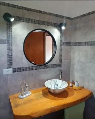 a bathroom with a bowl sink and a mirror at El buen retiro in Villa de Las Rosas