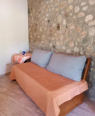 a bed with two pillows in a room at El buen retiro in Villa de Las Rosas