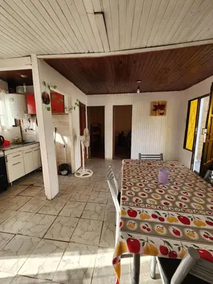a room with a table and a kitchen at Altos de Grecia Cabaña 1 in Villa Carlos Paz