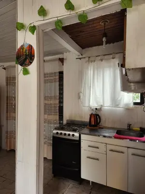 a kitchen with a stove top oven next to a window at Altos de Grecia Cabaña 1 in Villa Carlos Paz