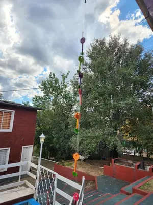 a swing set in a yard next to a house at Altos de Grecia Cabaña 2 in Villa Carlos Paz