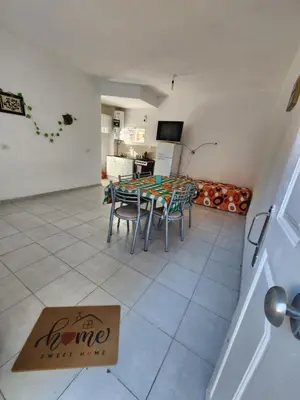 a dining room with a table and chairs in a room at Altos de Grecia Cabaña 2 in Villa Carlos Paz