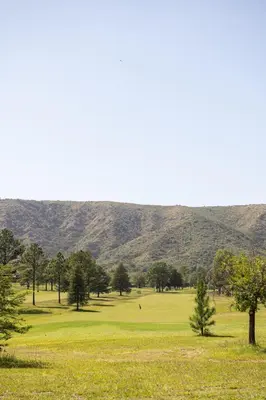 a view of a golf course with mountains in the background at Sierras Country Golf in San Antonio de Arredondo