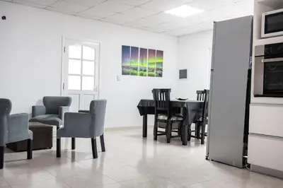 a dining room with a table and chairs at Sierras Country Golf in San Antonio de Arredondo