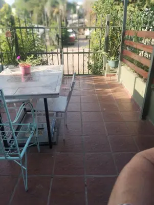 a patio with a table and chairs on a balcony at Doña Nelly 1 in Villa Carlos Paz
