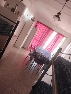 a living room with a window with pink curtains at Doña Nelly 1 in Villa Carlos Paz