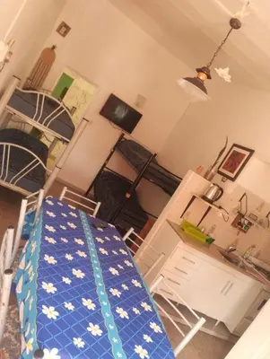 a living room with a table and chairs and a room with a table at Doña Nelly 1 in Villa Carlos Paz