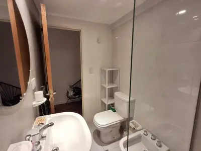 a bathroom with a toilet and a sink and a shower at Excepcional departamento en Nueva Córdoba in Cordoba