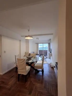 a dining room and living room with a table and chairs at Excepcional departamento en Nueva Córdoba in Cordoba
