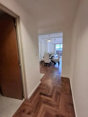 a hallway with a living room and a dining room at Excepcional departamento en Nueva Córdoba in Cordoba