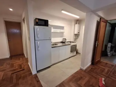 a kitchen with a white refrigerator and a sink at Excepcional departamento en Nueva Córdoba in Cordoba