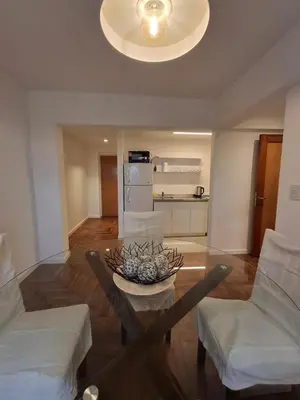 a living room with a table and two chairs at Excepcional departamento en Nueva Córdoba in Cordoba