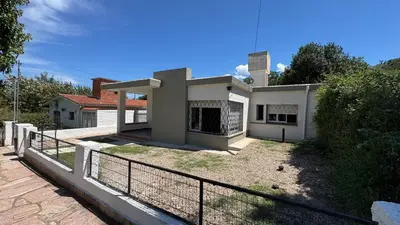 a house with a fence in front of it at La casa de Rena in Santa Rosa de Calamuchita