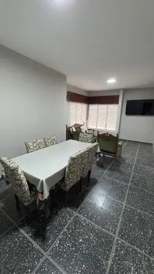 a dining room with a table and chairs in a room at La casa de Rena in Santa Rosa de Calamuchita