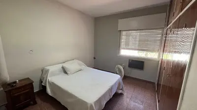 a small bedroom with a bed and a window at La casa de Rena in Santa Rosa de Calamuchita