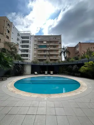 a swimming pool in front of a building at Departamento Gral Paz - Felix Frias 334 in Cordoba