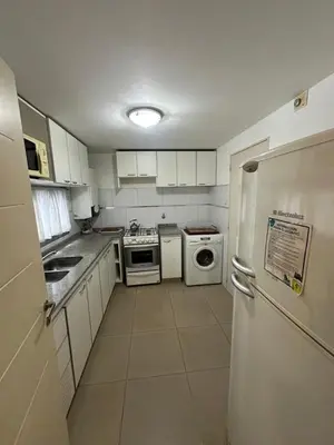 a kitchen with white appliances and a white refrigerator at Departamento Gral Paz - Felix Frias 334 in Cordoba