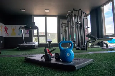 a gym with dumbbells and weights on the floor at Gran Hotel Cosquin in Cosquín