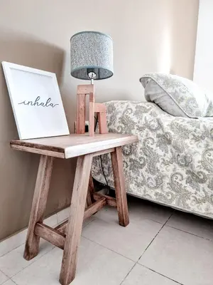 a wooden table with a laptop on it next to a couch at Dpto ob trejo - pileta asador quincho vista a las sierras in Cordoba
