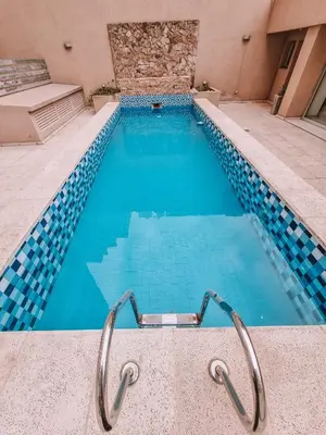 a swimming pool with blue water in a building at Dpto ob trejo - pileta asador quincho vista a las sierras in Cordoba