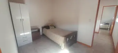 a bedroom with a bed and a dresser and a mirror at cabañas sunrise in Merlo