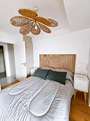 a bedroom with a large bed with a ceiling fan at Dpto Poeta lugones 72 - pileta terraza parrilla in Cordoba