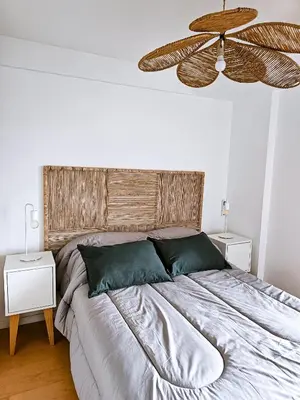 a bedroom with a large bed with a fan at Dpto Poeta lugones 72 - pileta terraza parrilla in Cordoba