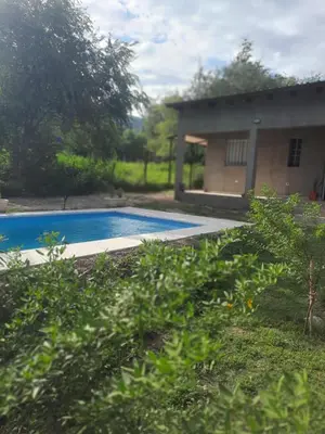 a swimming pool in front of a house at Cabaña La Kalma in Santa María
