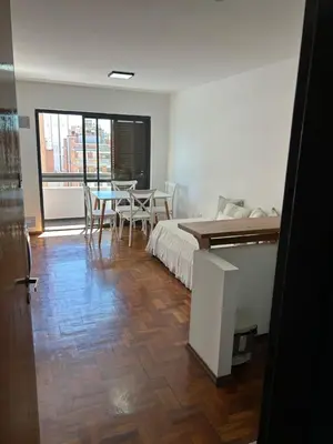 a bedroom with a bed and a table and chairs at Pueyrredón 76 in Cordoba