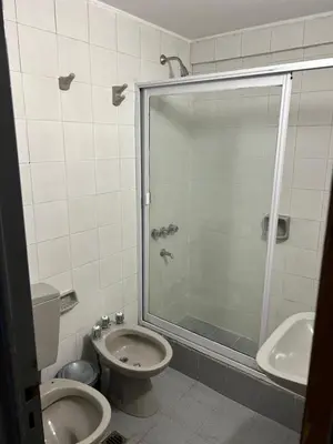 a bathroom with a shower and a toilet and a sink at Pueyrredón 76 in Cordoba