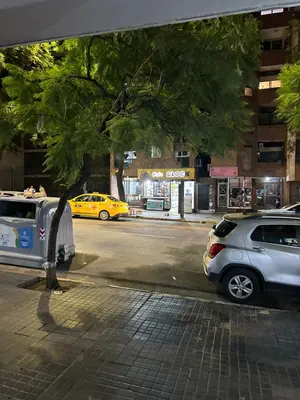 two cars parked on the side of a city street at Pueyrredón 76 in Cordoba